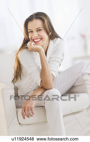 Stock Photo - Portrait of woman relaxing in chair. Fotosearch