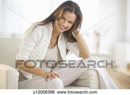Portrait of woman relaxing in chair View Large Photo Image Stock Photo - Portrait of woman relaxing in chair. Fotosearch