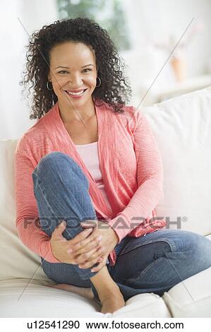 Portrait of woman sitting on sofa View Large Photo Image Stock Image - Portrait of woman sitting on sofa. Fotosearch