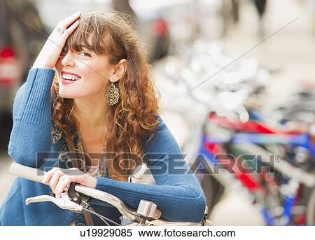 Portrait of woman with bike View Large Photo Image Stock Photography - Portrait of woman with bike. Fotosearch