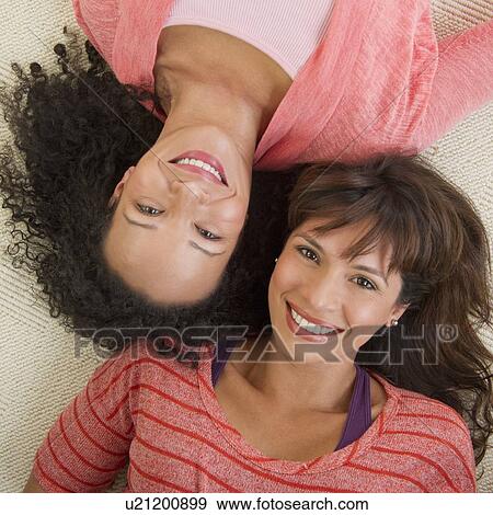 Portrait of women lying on floor View Large Photo Image Stock Photo - Portrait of women lying on floor. Fotosearch
