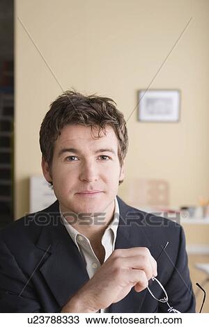 Stock Image - Portrait of young businessman. Fotosearch
