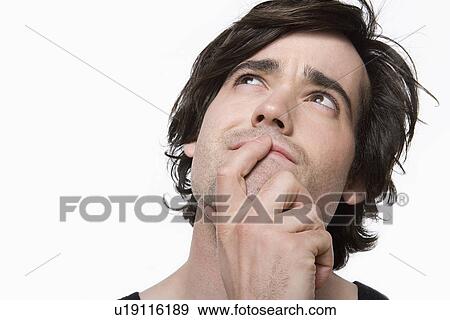 Stock Photo - Portrait of young man contemplating. Fotosearch