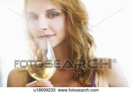 Portrait of young woman smelling wine, studio shot View Large Photo Image Stock Image - Portrait of young woman smelling wine, studio shot. Fotosearch