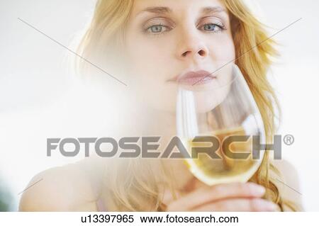 Portrait of young woman smelling wine, studio shot View Large Photo Image Stock Photography - Portrait of young woman smelling wine, studio shot. Fotosearch