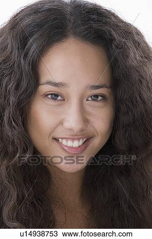Stock Image - Portrait of young woman smiling. Fotosearch