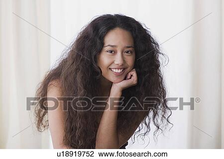 Stock Image - Portrait of young woman smiling. Fotosearch