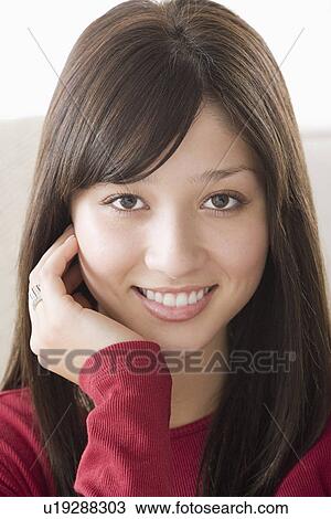 Stock Image - Portrait of young woman smiling. Fotosearch