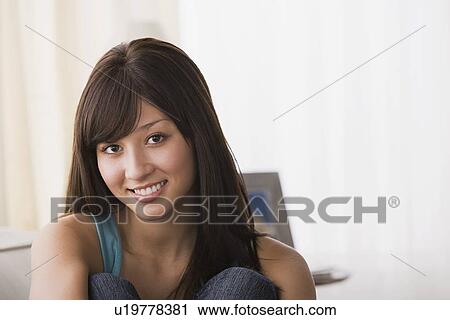 Stock Image - Portrait of young woman smiling. Fotosearch