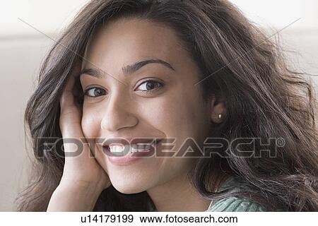 Stock Photo - Portrait of young woman smiling. Fotosearch
