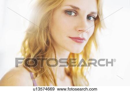 Portrait of young woman, studio shot View Large Photo Image Stock Photo - Portrait of young woman, studio shot. Fotosearch