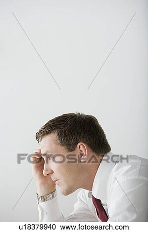 Stock Image - Profile of businessman contemplating. Fotosearch