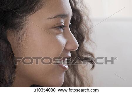 Profile of young woman smiling View Large Photo Image Stock Image - Profile of young woman smiling. Fotosearch