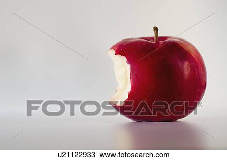 Stock Image - Red apple with missing bite, studio shot. Fotosearch