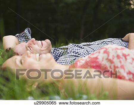 Roaring Brook Lake, Couple lying on grass View Large Photo Image Stock Photography - Roaring Brook Lake, Couple lying on grass. Fotosearch