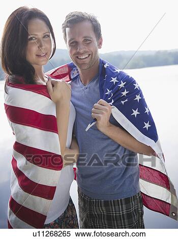 Stock Photography - Roaring Brook Lake, Couple wrapped in American flag. Fotosearch