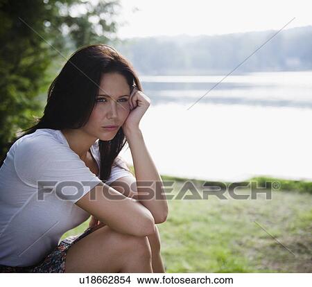 Picture - Roaring Brook Lake, Lonely woman sitting by lake. Fotosearch