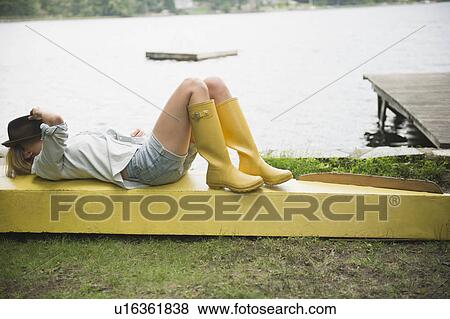 Roaring Brook Lake, Woman lying on pier by lake View Large Photo Image Stock Photo - Roaring Brook Lake, Woman lying on pier by lake. Fotosearch