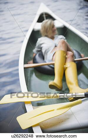 Roaring Brook Lake, Woman sitting in boat View Large Photo Image Stock Photo - Roaring Brook Lake, Woman sitting in boat. Fotosearch