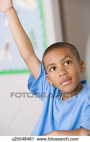 Schoolboy (6-7) raising hand View Large Photo Image Stock Image - Schoolboy (6-7) raising hand. Fotosearch