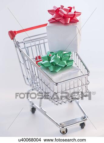 Picture - Shopping cart with christmas gifts. Fotosearch