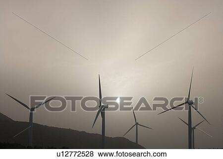 Silhouettes of wind turbines View Large Photo Image Stock Photo - Silhouettes of wind turbines. Fotosearch