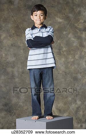 Smiling boy (8-9) standing, studio shot View Large Photo Image Stock Photo - Smiling boy (8-9) standing, studio shot. Fotosearch