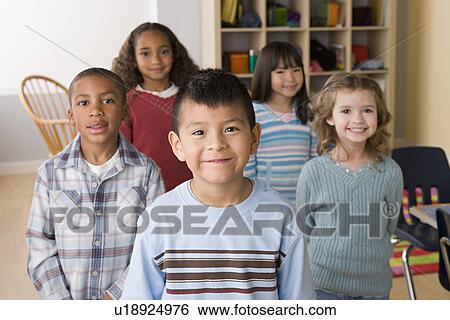 Smiling children (6-7) in classroom View Large Photo Image Stock Photograph - Smiling children (6-7) in classroom. Fotosearch