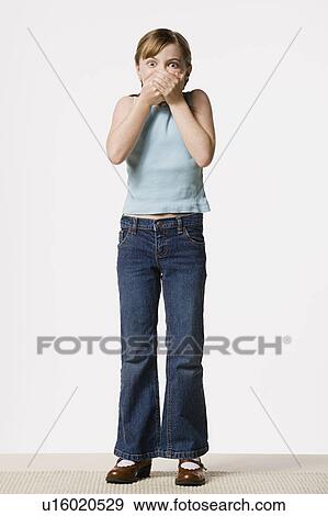 Smiling girl (8-9) covering her mouth, studio shot View Large Photo Image Stock Photo - Smiling girl (8-9) covering her mouth, studio shot. Fotosearch