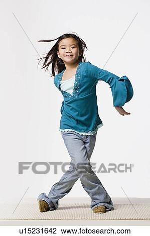 Smiling girl (8-9) dancing, studio shot View Large Photo Image Stock Image - Smiling girl (8-9) dancing, studio shot. Fotosearch