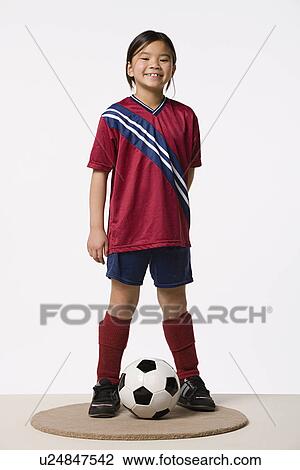 Smiling girl (8-9) wearing soccer uniform, studio shot View Large Photo Image Stock Image - Smiling girl (8-9) wearing soccer uniform, studio shot. Fotosearch