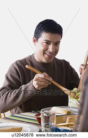 Smiling man dining at table View Large Photo Image Stock Photo - Smiling man dining at table. Fotosearch