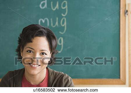 Smiling teacher in classroom View Large Photo Image Stock Image - Smiling teacher in classroom. Fotosearch