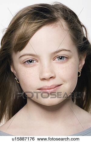 Stock Photograph - Studio portrait of girl (8-9), close up. Fotosearch