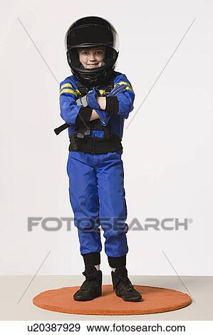 Stock Photo - Studio portrait of girl (8-9) in crash helmet. Fotosearch