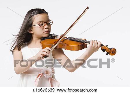 Studio portrait of girl (8-9) playing violin View Large Photo Image Stock Photo - Studio portrait of girl (8-9) playing violin. Fotosearch