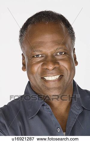 Stock Photo - Studio portrait of mature man. Fotosearch