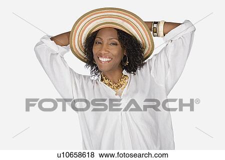 Stock Photo - Studio portrait of mature woman wearing hat. Fotosearch