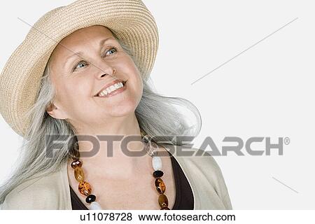 Studio portrait of mature woman wearing hat View Large Photo Image Stock Photo - Studio portrait of mature woman wearing hat. Fotosearch