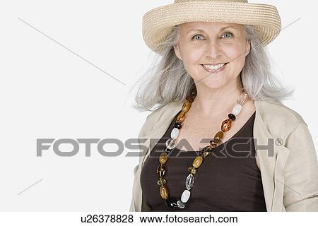 Stock Photo - Studio portrait of mature woman wearing hat. Fotosearch