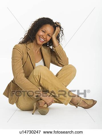 Stock Photo - Studio portrait of mid adult woman. Fotosearch