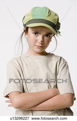 Studio portrait of sly girl (8-9) View Large Photo Image Stock Photo - Studio portrait of sly girl (8-9). Fotosearch