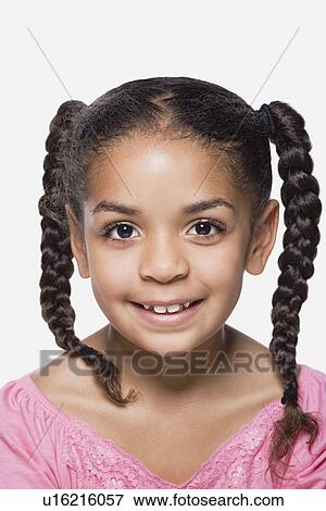 Studio portrait of smiling girl (8-9) with plaits, close up View Large Photo Image Stock Photo - Studio portrait of smiling girl (8-9) with plaits, close up. Fotosearch