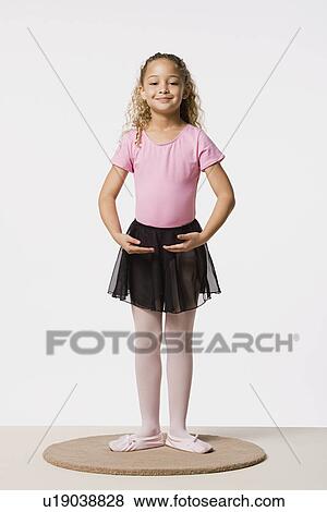 Studio portrait of smiling girl (8-9) in ballet costume View Large Photo Image Stock Photo - Studio portrait of smiling girl (8-9) in ballet costume. Fotosearch