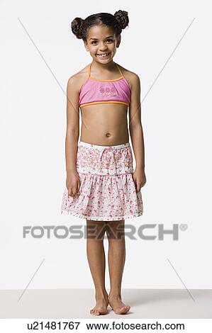 Stock Photo - Studio portrait of smiling girl (8-9) with hair buns. Fotosearch