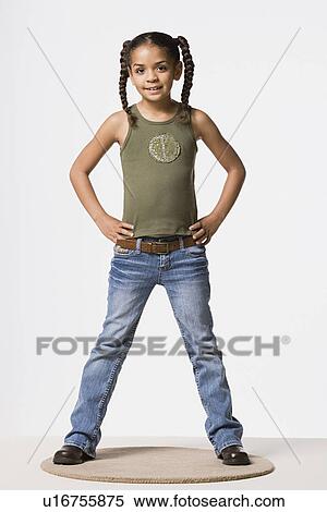 Stock Photography - Studio portrait of smiling girl (8-9) with plaits. Fotosearch