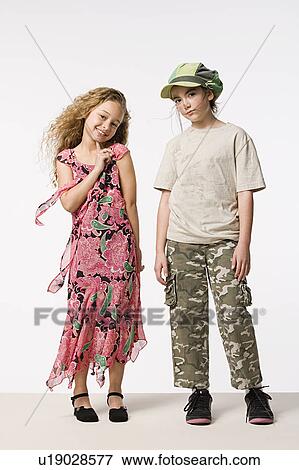 Stock Photo - Studio portrait of two smiling girls (8-9) . Fotosearch