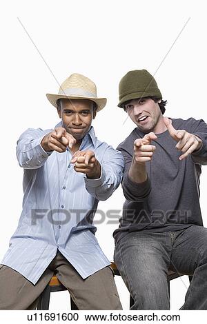 Stock Image - Studio portrait of two young men playing. Fotosearch