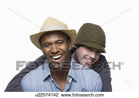 Stock Image - Studio portrait of two young men embracing. Fotosearch