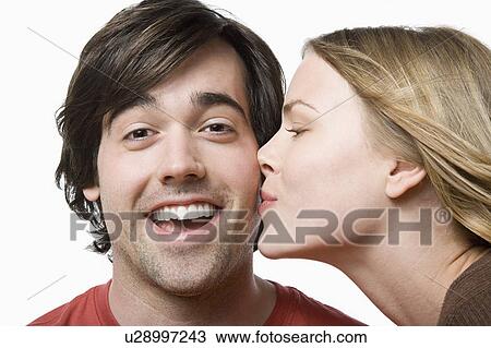Studio portrait of young couple kissing View Large Photo Image Stock Image - Studio portrait of young couple kissing. Fotosearch